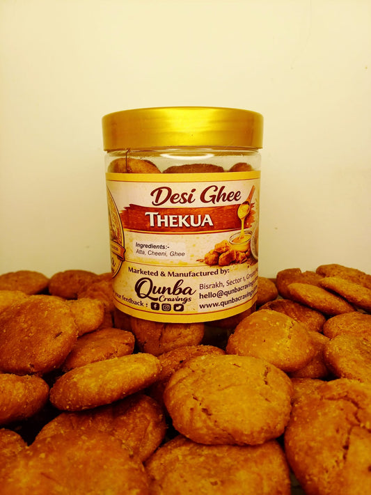 Jar of Desi Ghee Thekua surrounded by cookies on a beige background